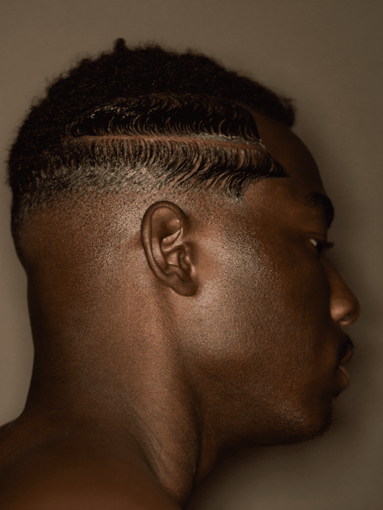 A crisp skin fade with a sharp line-up and defined waves, photographed in profile.
