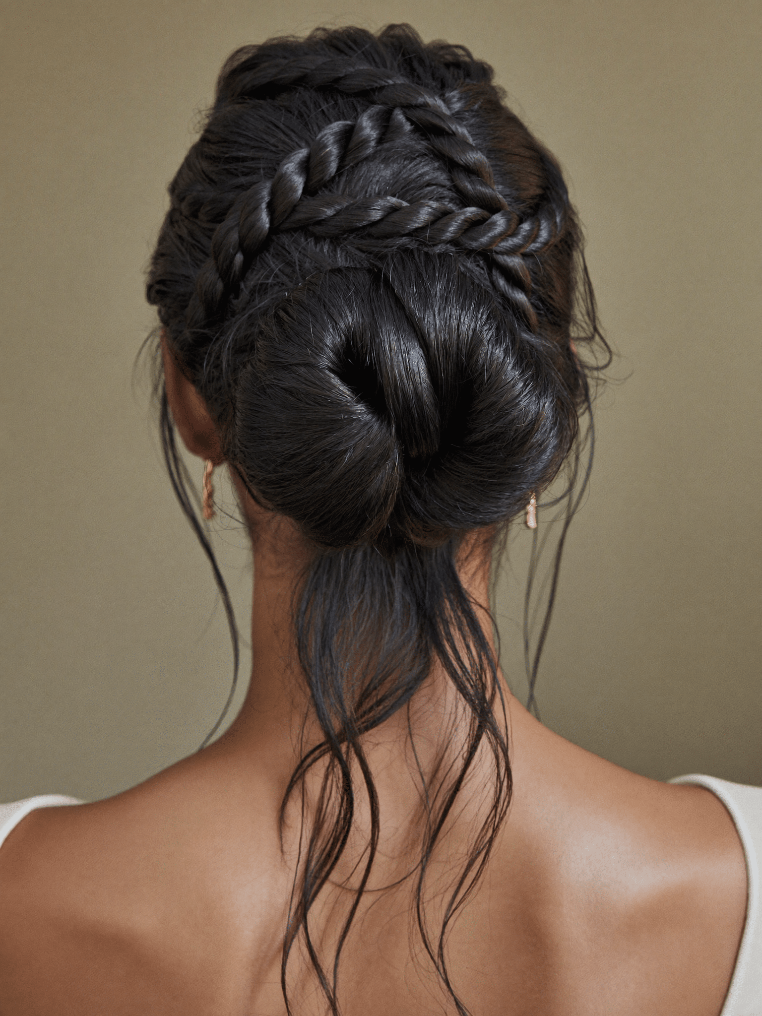 An elegant bridal updo with twisted rope detail finishing in a low chignon.